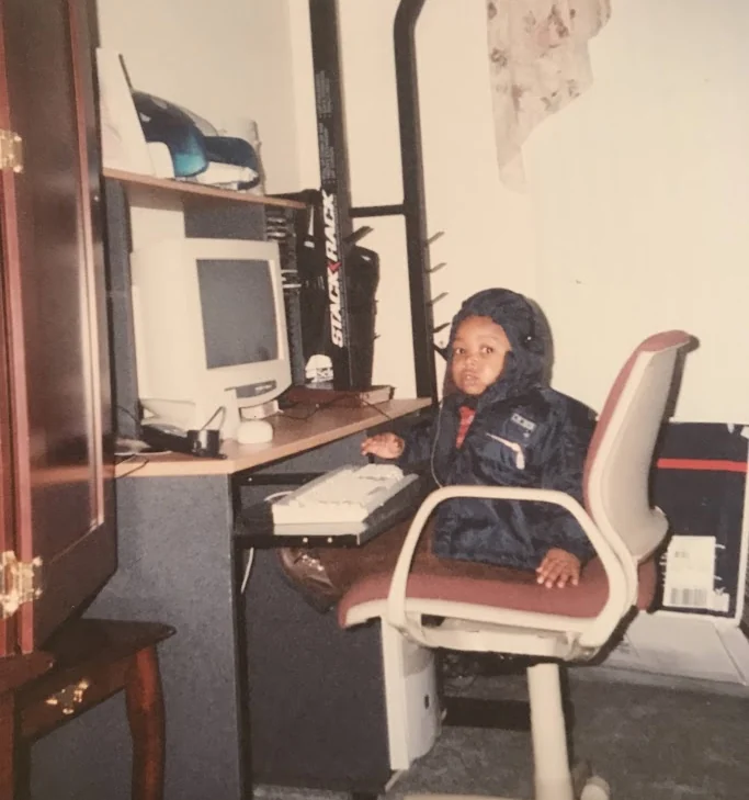Udenna using a computer as a child